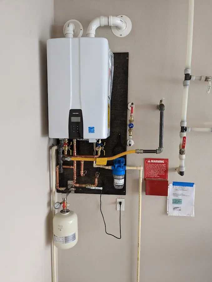 Professional plumber installing copper piping in a Bellefontaine Neighbors home